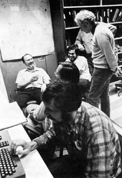 Success is measured on the faces (left to right) of M. Hentges (at keyboard), P. Martin, G. Tool, D. Wolff, L. Lederman (standing), and P. Limon (background)