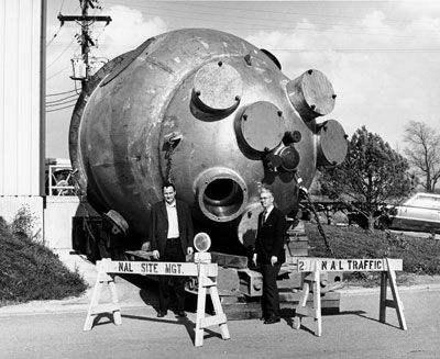 (L to R) Drs. F. R. Huson and Wm. B. Fowler of NAL Bubble Chamber Section, with the newly-arrived 15 ft. bubble chamber