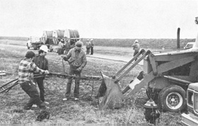 Tying down cable to a tractor before takeoff