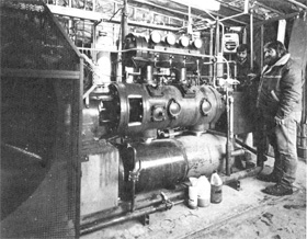 Mike Hentges (L), Jack Johnson at refurbished compressor of purification system