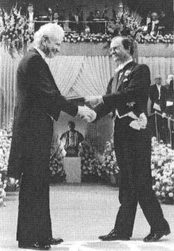 Leon receiving Nobel Prize from King Carl XVI Gustaf of Sweden