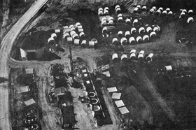 An aerial view of one of the two casting yards on the NAL construction site. Main Ring sections are pre-cast in the cubicles at the left. They are stored in the field and transported by truck to the nearby Main Ring excavation as they are needed.