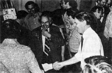 Dr. Wilson (R) shaking hands with fellow employees. Dr. Goldwasser (ctr.), Harry Howe, Safety Off.(plaid shirt)